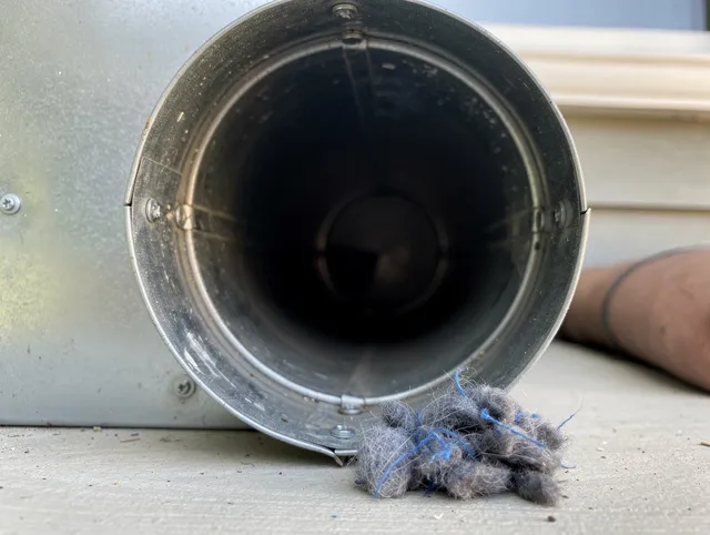 Brandon Dryer Vent Cleaning technician using specialized equipment to clear severe dryer vent blockage in Brandon